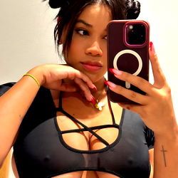 Model in a Crop Top With Her Hair Up, Taking a Selfie