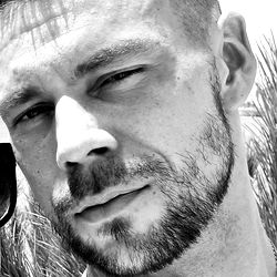 Angelo Godshack, a tattooed model with goatee and beard