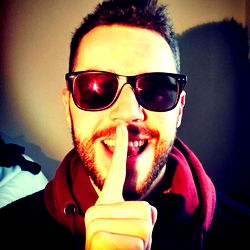 OnlyFans Model Alex White Teases a Secret With a Finger Over His Mouth