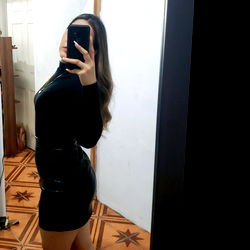 Abigail Her, the onlyfans model posing in a mirror with her back to us