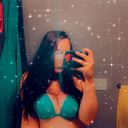 Model in Turquoise Bikini Standing in Bathroom