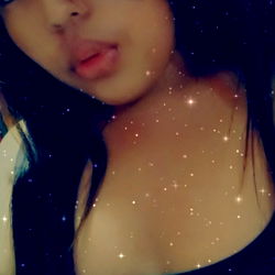 A woman posing for a selfie with makeup and a smile