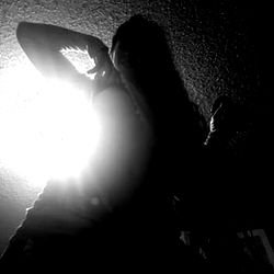 Intimate Baby Doll Nae Photoshoot in Shadowy Environment