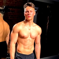 Fit Model Showcasing Shirtless Physique in Gym Setting