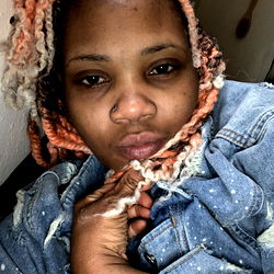 A Young Adult Woman with Braided Hair and a Tattoo