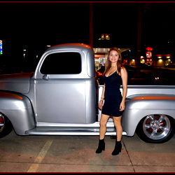 A Woman Standing Next to a Model Car