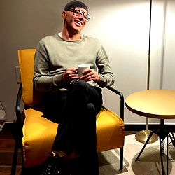 Man with beard sitting in a room