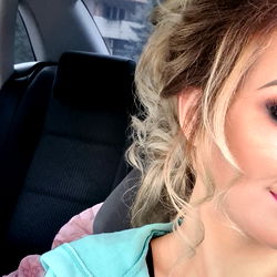 Alexandra from New Amsterdam, capturing a candid moment in her car.