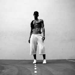 Model pose on a road with hand on hip, looking down the street