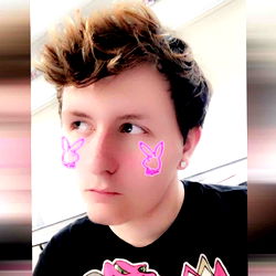 A young man with bunny ears and a concerned expression