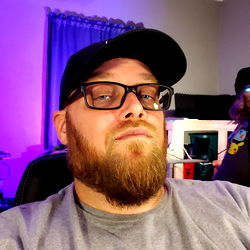 A Man Sitting in a Room with a Purple Light