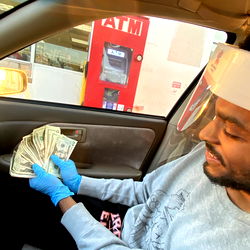 Man Holding Money in a Car