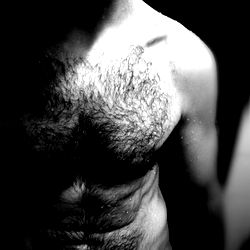 Mature man with a beard and tattooed arms in black and white