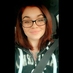 Smiling Woman with Red Hair in Car Seat