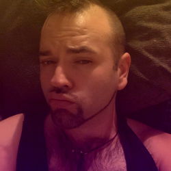 A Tattooed Man in a Casual Shirt