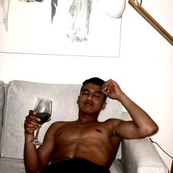 Antonio from Houston, casually posing on a couch with a wine glass