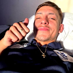 Alejandro Diaz, 25 year old male from Cordoba, showing a thumbs up while giving a peace sign