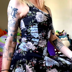 Model Showcasing Tattooed Arm and Floral Dress