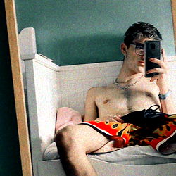 John, A Fitness Enthusiast, Captures His Muscle Definition in a Mirror Selfie