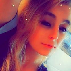 Annalease, a young woman with tattoos posing for the camera on OnlyFans