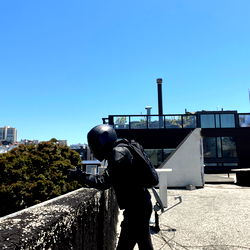 Ron Flores, a model in San Francisco, leaning against a building ledge.