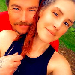 Kinky-Thots model posing for a photo with a partner in a park