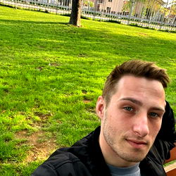 Young Man in Park with Cell Phone