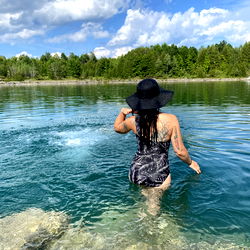 Aloisa in a Scenic Outfit Wearing Swimsuit on Rocky Shore