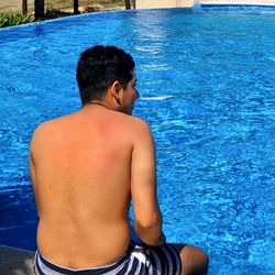 A person relaxing by a pool