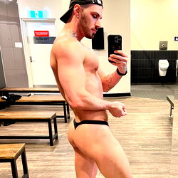 Model Showcasing Fitness Physique in Gym