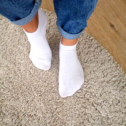 Model Showcasing Socks on the Rug