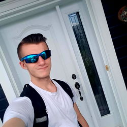 Young Man in Sunglasses Standing Outside Home