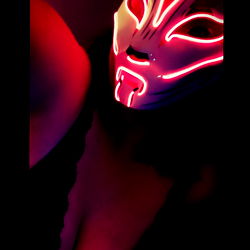 Vivid and Stylish Masked Figure Against a Dark Background