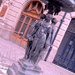 Ornate Fountain with Statues on City Street