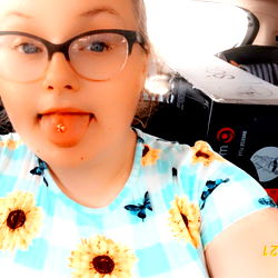 Hannah Poses in Car with Playful Tongue-Out Expression