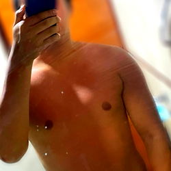 Sexy and Shirtless OnlyFans Model Showcasing Physique in Mirror