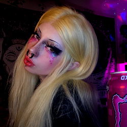 Glamorous Onlyfans model with vibrant hair and dramatic makeup