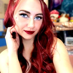 Red-haired woman with makeup and jewelry