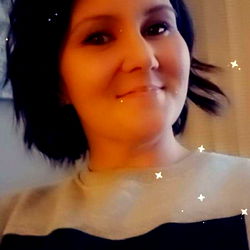 A Thicc Woman in a Casual Sweater, Smiling at the Camera