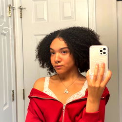 Autumn, a model on Onlyfans poses in front of a mirror with a phone