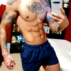 Fit and Tattooed Man in Blue Shorts