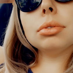 Woman in Sunglasses and Floppy Hat, Sitting in Car