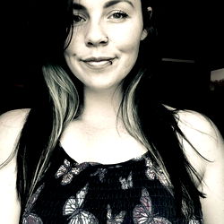 Stylish OnlyFans Model in Flower Tank Top, Smiling and Looking Ahead