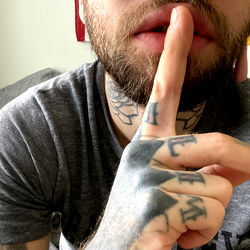 Andre Call: Tattooed Man with Sunglasses, Finger on Mouth, and Beard