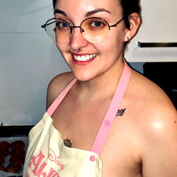 Smiling Woman in Kitchen with Tattoo, Glasses and Bare Shoulders