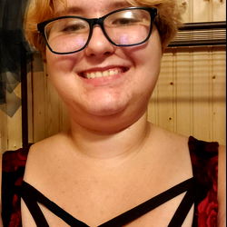 Smiling Woman in Red Dress with Crossed Straps