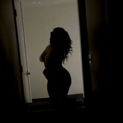 OnlyFans Model in a Dimly Lit Hallway