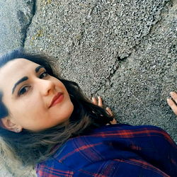 A Woman Posing in Front of a Rough Surface