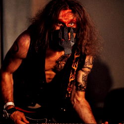 Guitarist with a punk rock aesthetic, posing with an electric guitar