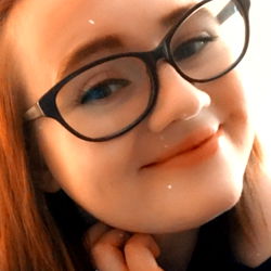 Kitty, a young adult female with glasses, smiling at the camera